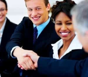 Two business men shaking hands at international business meeting.